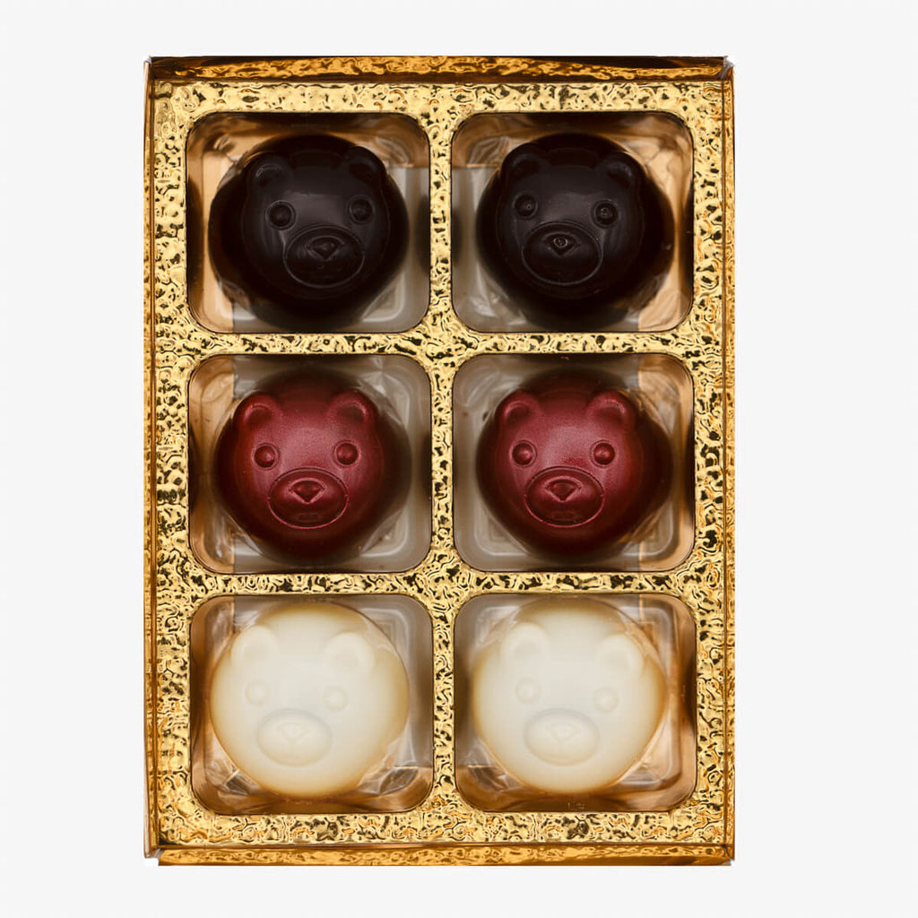 Small box of La Choc bear-shaped chocolates in dark, milk, and white varieties, displayed in gold packaging.