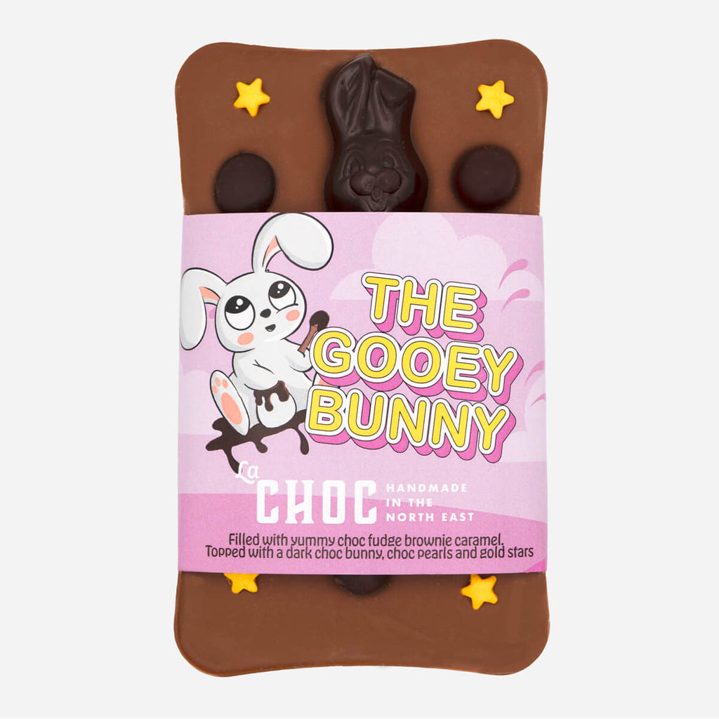 The Gooey Bunny chocolate bar by La Choc, featuring a dark chocolate bunny, chocolate pearls, and gold stars on a milk chocolate base.