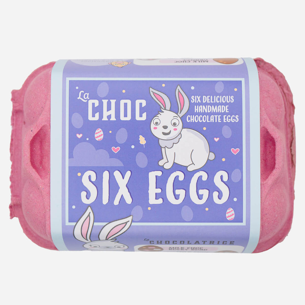 Six handmade chocolate eggs by La Choc, packaged in a pink egg carton with a playful bunny-themed label.