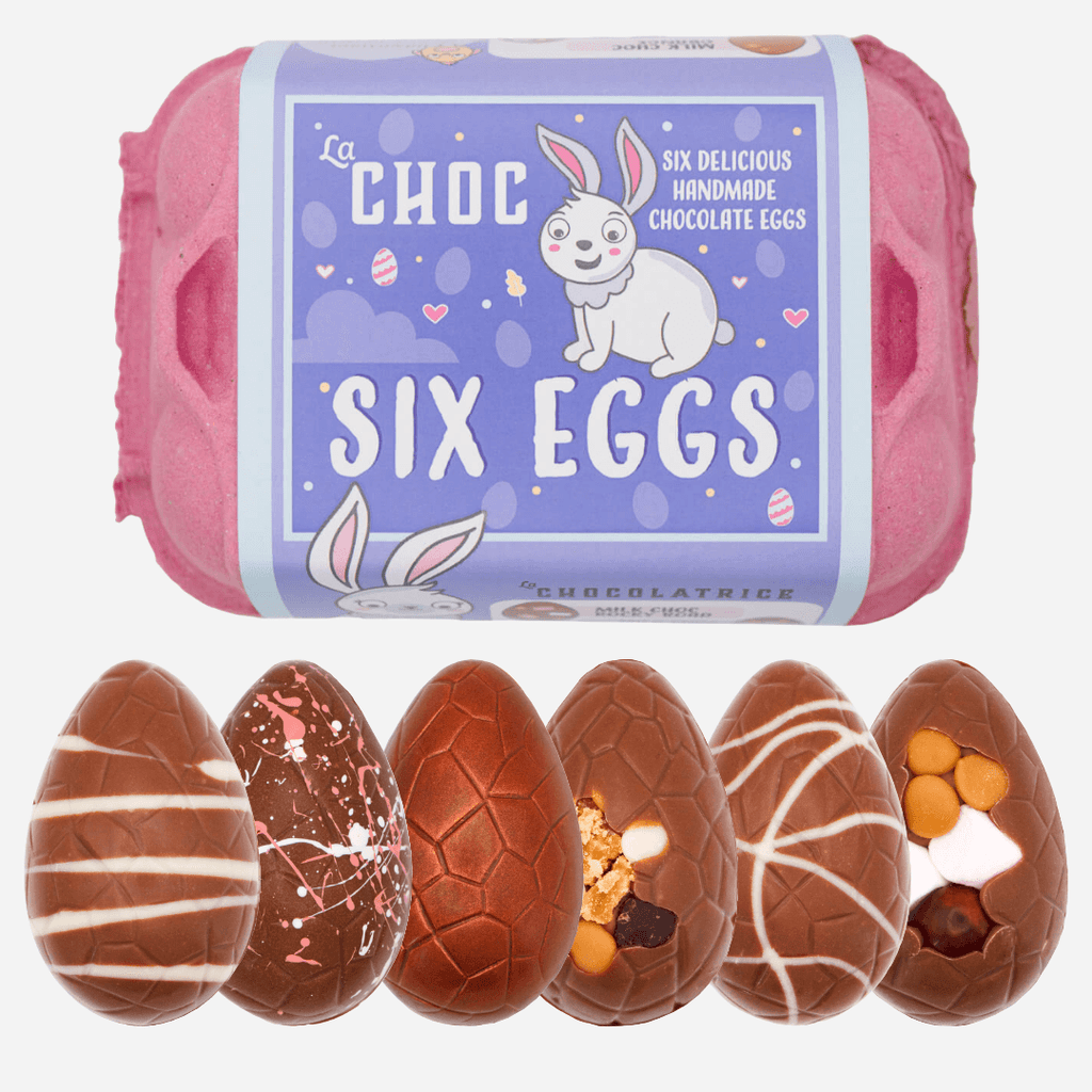 A pink carton of La Chocolatrice's Six Eggs selection, featuring six handmade chocolate Easter eggs with unique designs, including white chocolate stripes, colourful splatter, caramel-filled, and nut-studded variations.