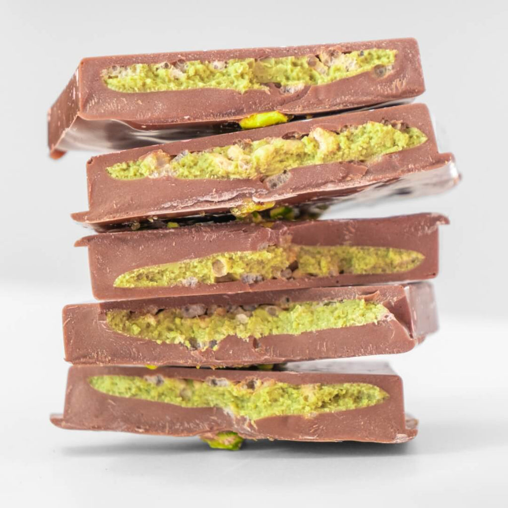 tack of pistachio chocolate bars from La Chocolatrice with visible green pistachio filling